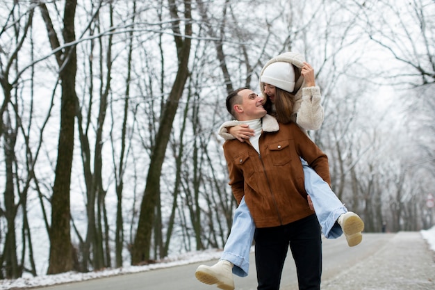 Medium shot man carrying girlfriend