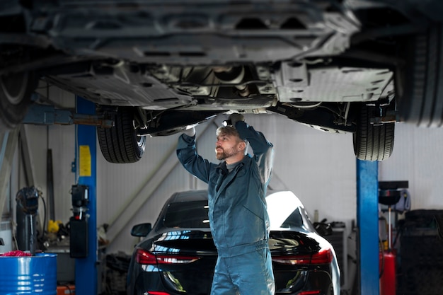 Free photo medium shot man checking car