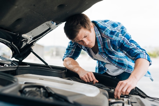 Free Photo medium shot of man checking engine