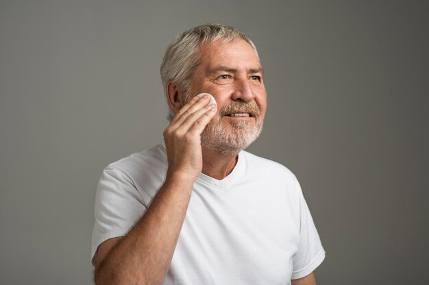 Medium shot man cleaning face