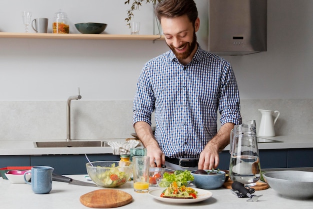 Medium shot man cooking in kitchen