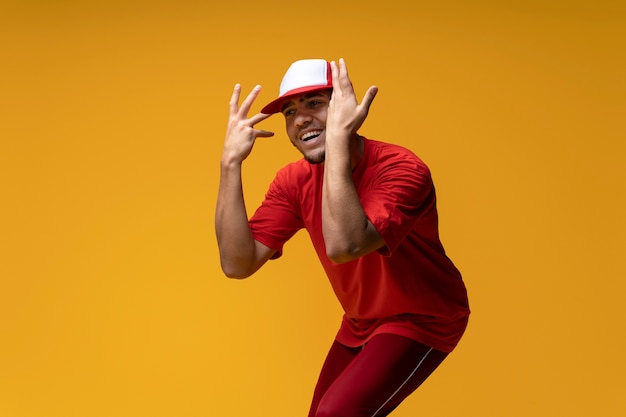 Medium shot man dancing with yellow background