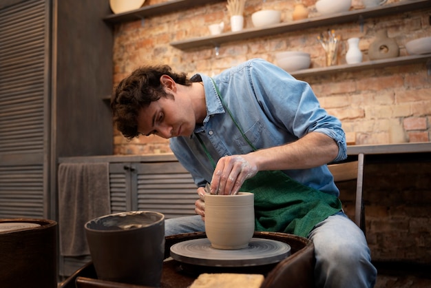 Free Photo medium shot man doing pottery