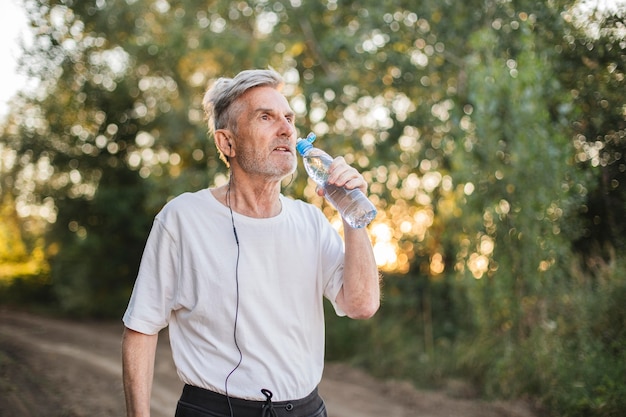 Medium shot man drinking water