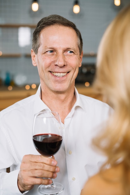 Medium shot of man drinking wine