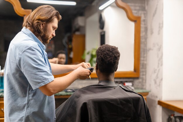 Medium shot man getting a haircut