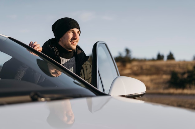 Medium shot man getting out of car