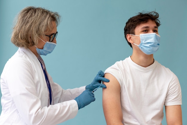 Medium shot man getting vaccine