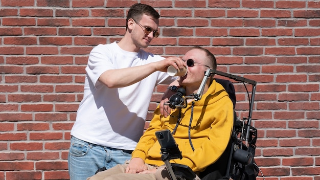 Medium shot man helping disabled friend