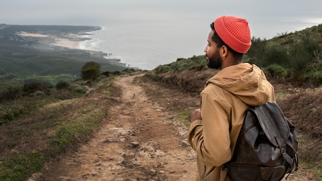 Free photo medium shot man on hiking tour