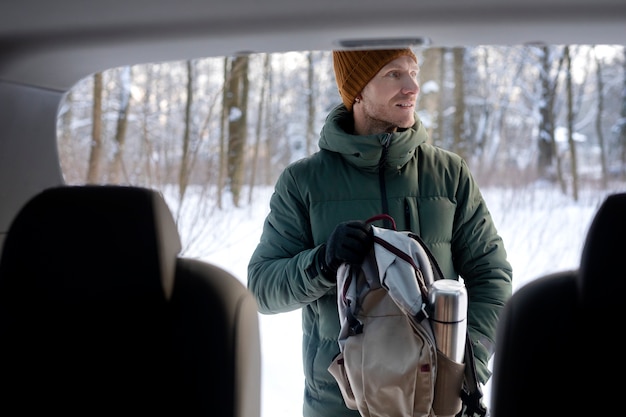 Free Photo medium shot man holding backpack