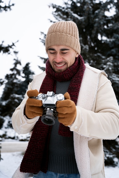 Medium shot man holding camera