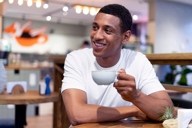 Medium shot man holding coffee cup