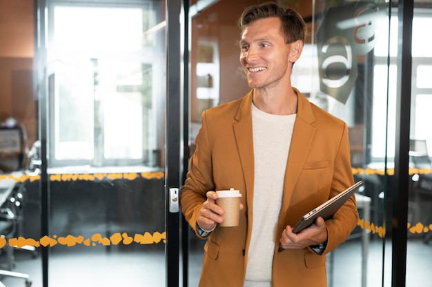 Free photo medium shot man holding coffee cup