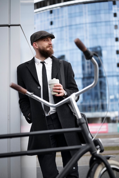 Free photo medium shot man holding coffee cup