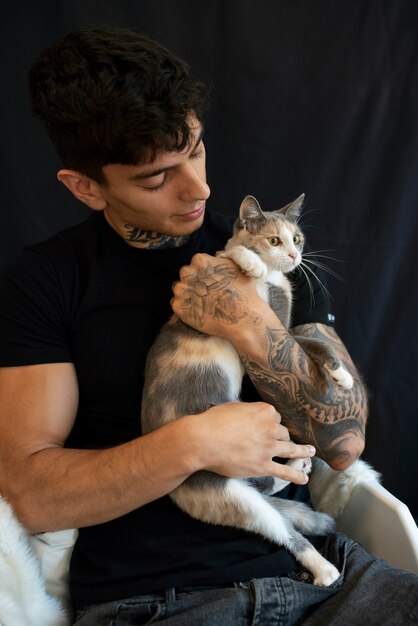 Medium shot man holding cute cat