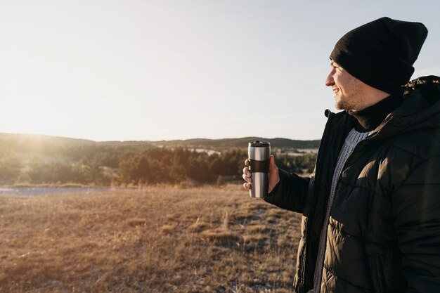 Medium shot man holding flask