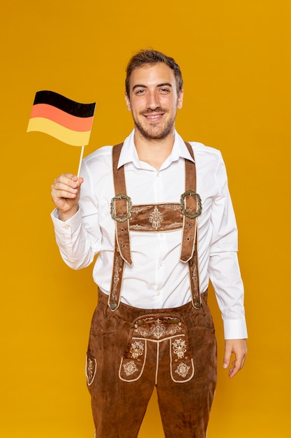 Medium shot of man holding german flag