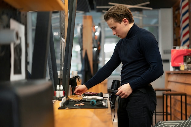 Medium shot man holding hair dryer