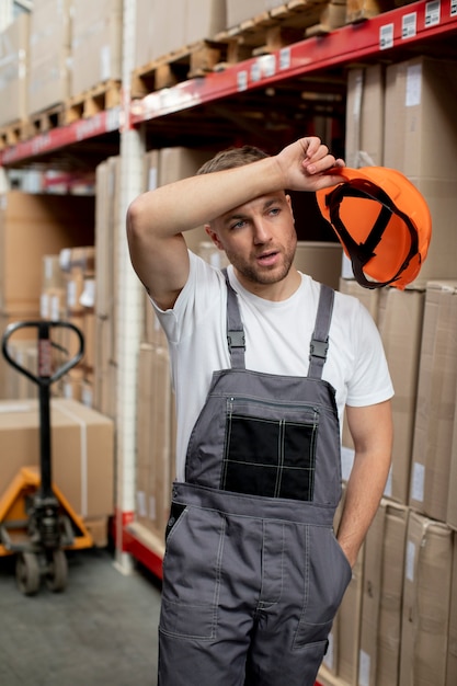 Free photo medium shot man holding helmet