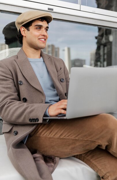 Medium shot man holding laptop