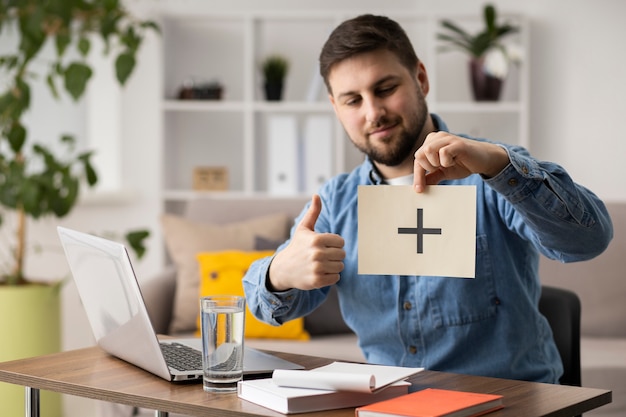 Medium shot man holding paper piece