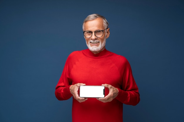 Free photo medium shot man holding phone