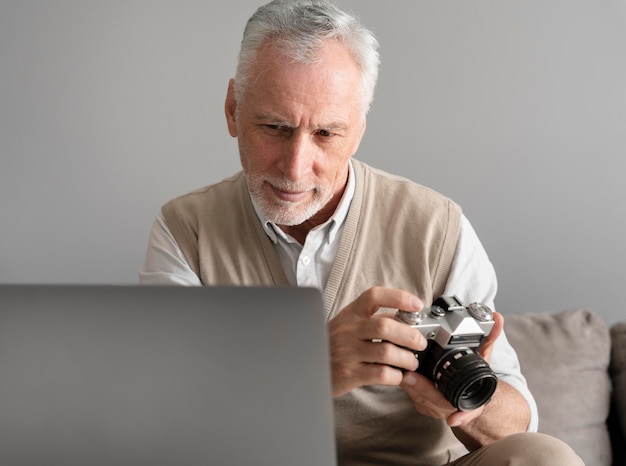 Free Photo medium shot man holding photo camera