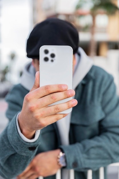 Medium shot man holding smartphone