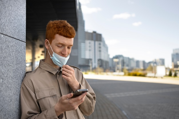 Medium shot man holding smartphone