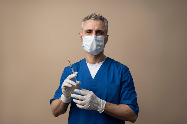 Medium shot man holding syringe