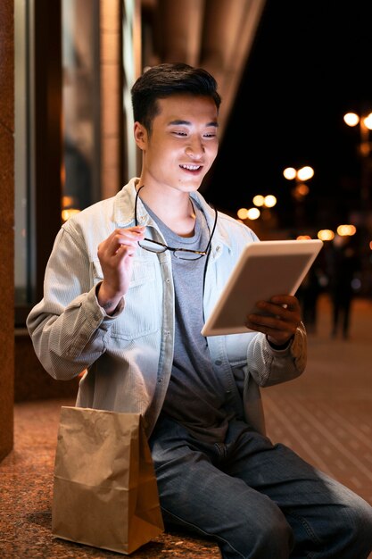 Medium shot man holding tablet