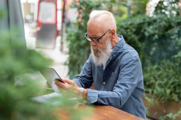 Medium shot man holding tablet