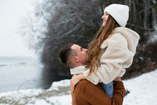 Medium shot man holding up woman