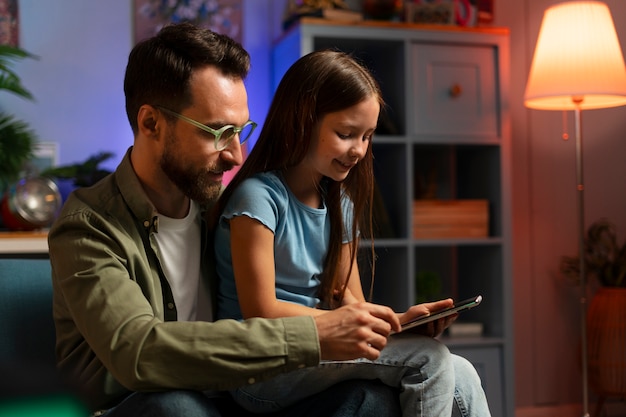 Medium shot man and kid relaxing at home