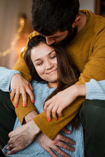 Medium shot man kissing woman on head