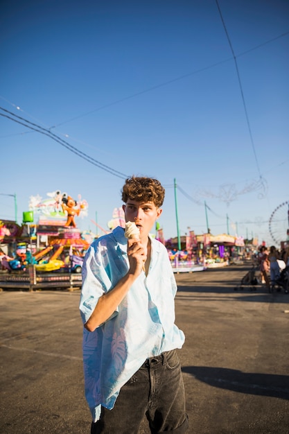 Free photo medium shot man licking ice cream