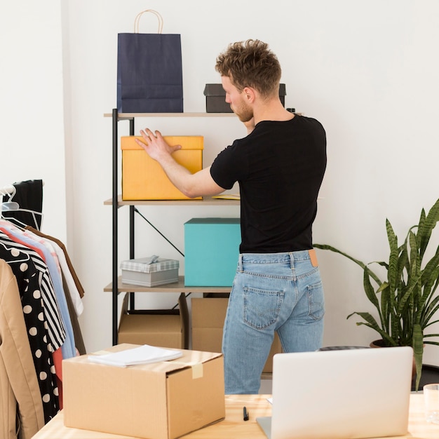 Free Photo medium shot man looking at box