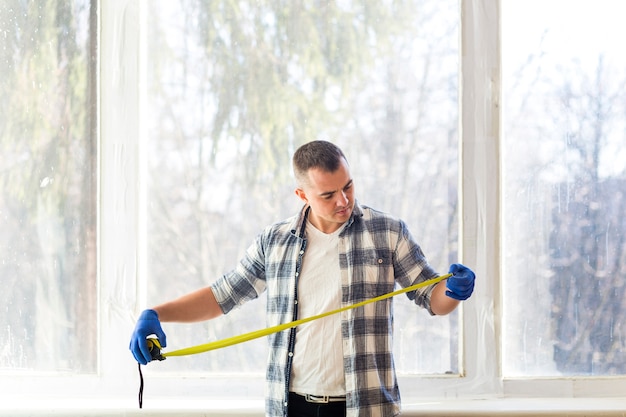 Free photo medium shot of man looking at tape measure