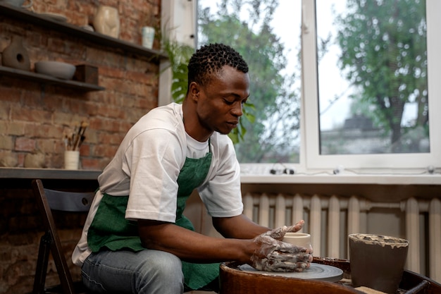 Medium shot man making bowl