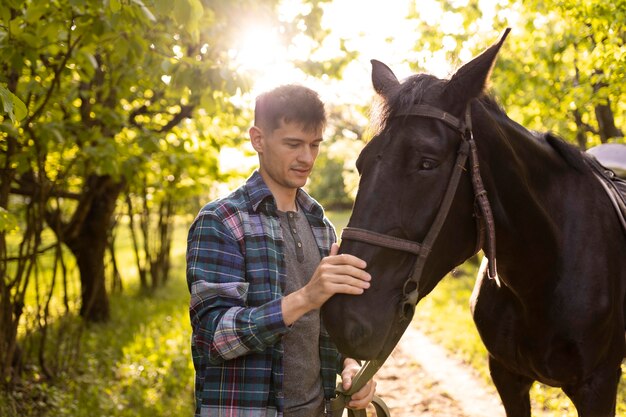 Medium shot man petting horse outdoors