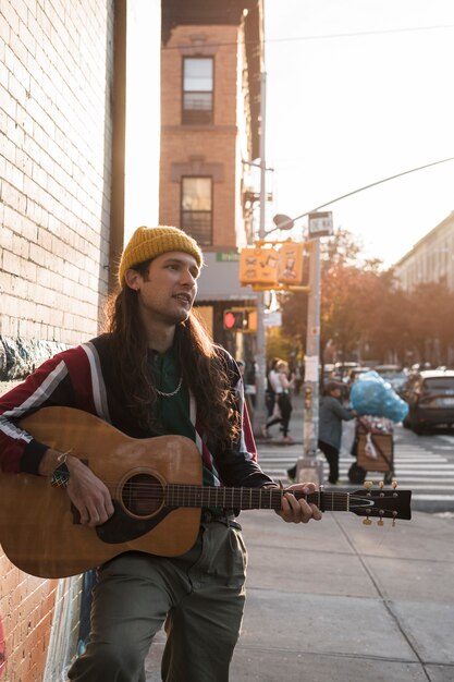 Medium shot man playing the guitar