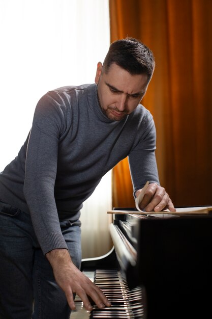 Medium shot man playing piano