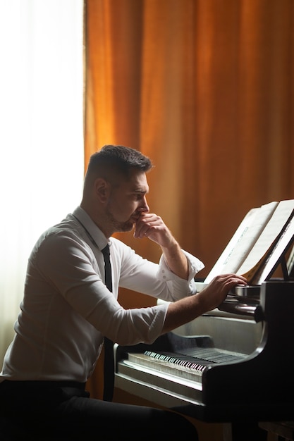 Medium shot man playing piano