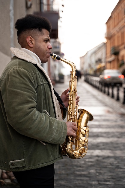 Free Photo medium shot man playing saxophone