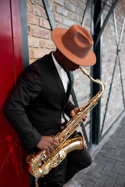 Free Photo medium shot man playing the saxophone