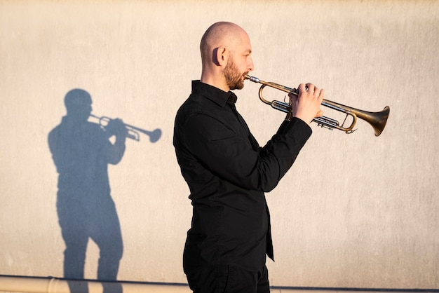 Medium shot man playing trumpet outside