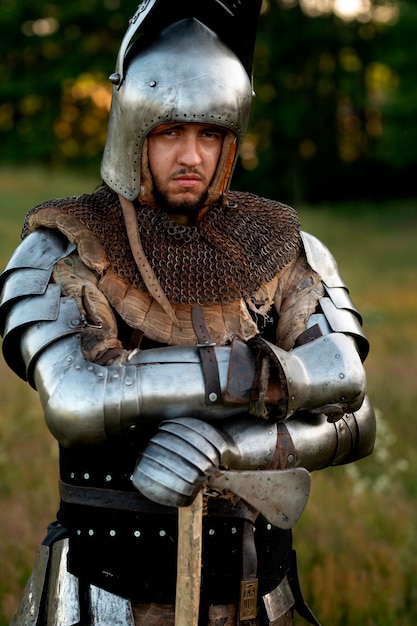 Medium shot man posing as a medieval soldier