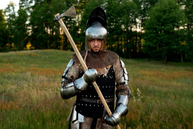 Medium shot man posing as a medieval soldier