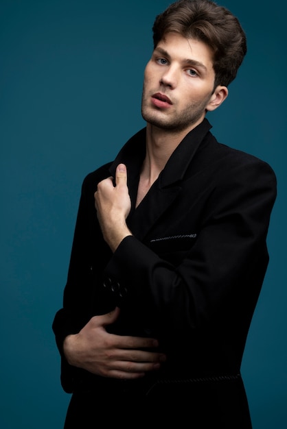 Medium shot man posing with blue background